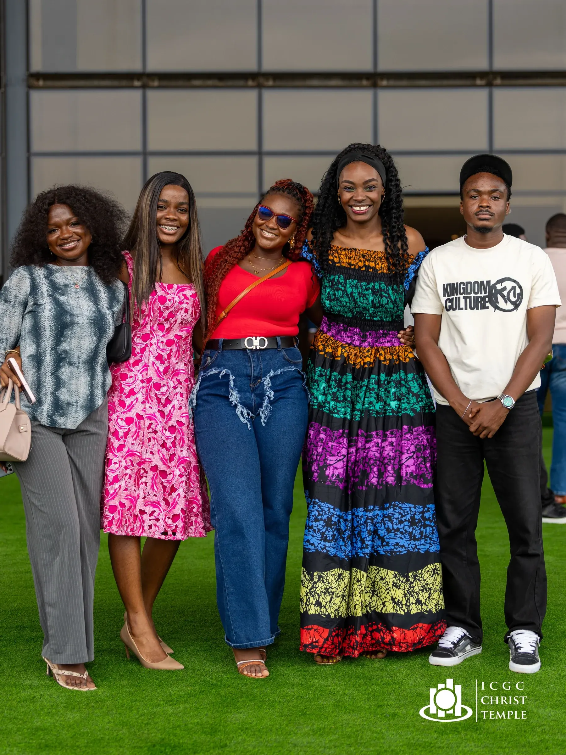 A group of friends in colourful clothing gathered outside Christ Temple